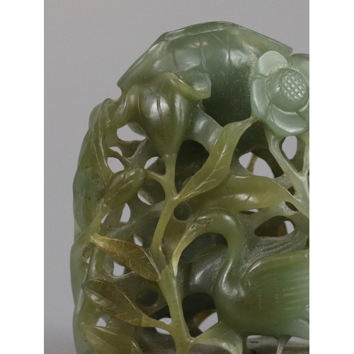 198 - A Sage Green Jade Hat Finial, Yuan/Ming dynasty, well carved from a pebble in deep openwork, with a ... 