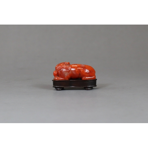 200 - A Carnelian Cat, c.1800,  the seated beast with a bell on his collar, wood stand: together with an a... 