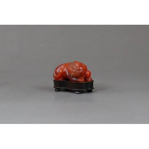 200 - A Carnelian Cat, c.1800,  the seated beast with a bell on his collar, wood stand: together with an a... 