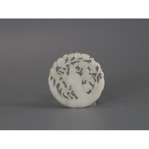 201 - A Pierced White Jade Roundel, 18th century,  carved with a gentleman standing on a curved flowering ... 