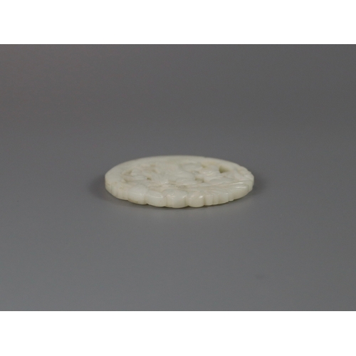 201 - A Pierced White Jade Roundel, 18th century,  carved with a gentleman standing on a curved flowering ... 