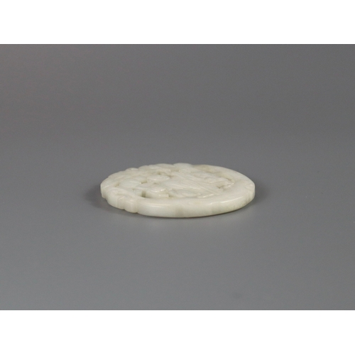 201 - A Pierced White Jade Roundel, 18th century,  carved with a gentleman standing on a curved flowering ... 