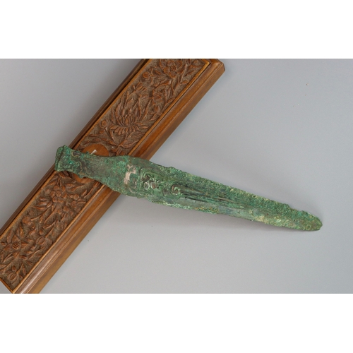 208 - An Archaic Bronze Spearhead, Shang/ early Western Zhou dynasty,  the slender blade finely decorated ... 