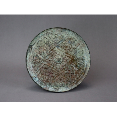 211 - An Archaic Bronze Mirror, Warring States,  thinly cast, and finely decorated in low relief with flor... 