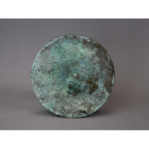 211 - An Archaic Bronze Mirror, Warring States,  thinly cast, and finely decorated in low relief with flor... 