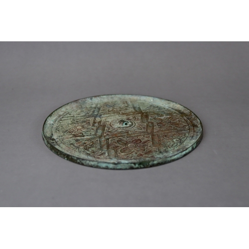 211 - An Archaic Bronze Mirror, Warring States,  thinly cast, and finely decorated in low relief with flor... 