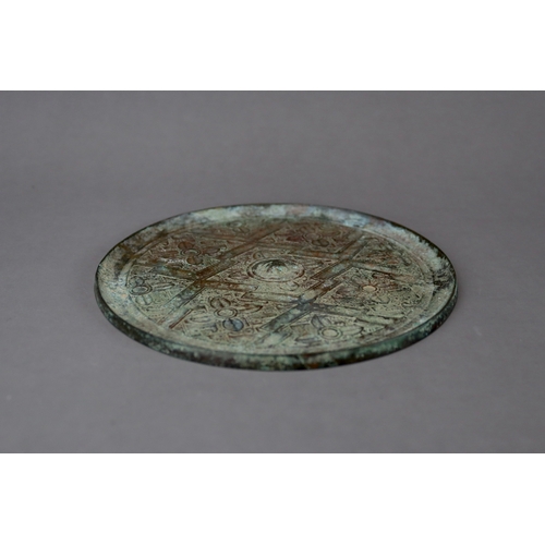 211 - An Archaic Bronze Mirror, Warring States,  thinly cast, and finely decorated in low relief with flor... 