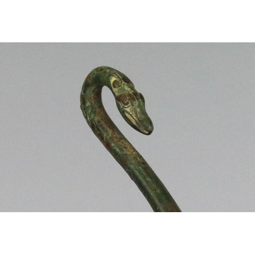 214 - An Archaic Bronze Belthook, Warring States, very finely worked, the bronze with a soft green patina,... 