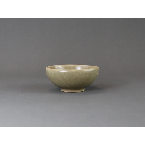 223 - A Longquan Celadon Cup, Song dynasty the rounded sides rising from a tapered foot, applied overall s... 