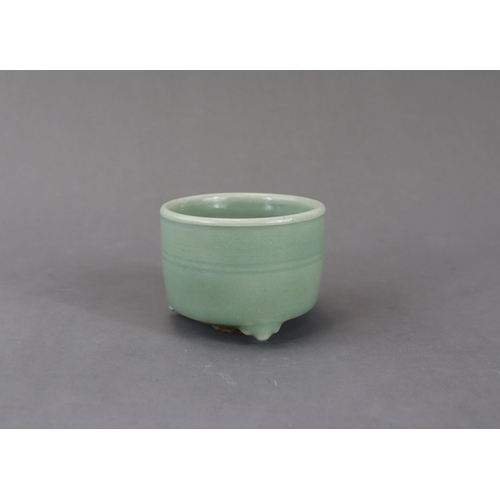 225 - A Longquan Celadon Tripod Cylindrical Incense Burner, Yuan dynasty raised on three ruyi feet, the ex... 