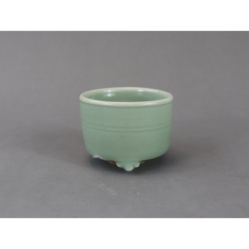 225 - A Longquan Celadon Tripod Cylindrical Incense Burner, Yuan dynasty raised on three ruyi feet, the ex... 