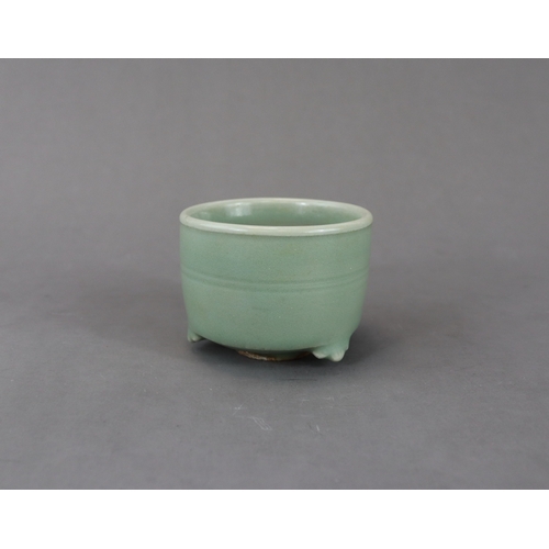 225 - A Longquan Celadon Tripod Cylindrical Incense Burner, Yuan dynasty raised on three ruyi feet, the ex... 