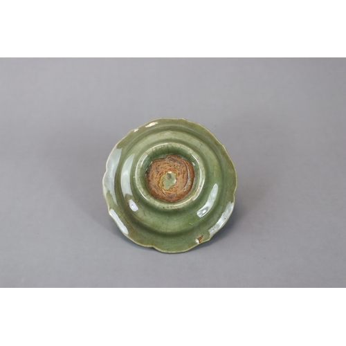 226 - A Longquan Celadon Cupstand, Yuan dynasty heavily potted, the raised cup holder with curved sides ab... 