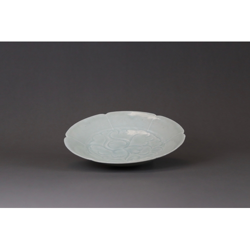 227 - A Qingbai Lobed Peony Dish, Song dynasty the wide everted rim divided into six lobes, freely carved ... 