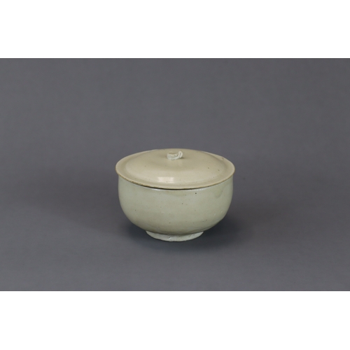 229 - A Ding-type White-glazed Bowl and Cover, Song dynasty the deep, slightly incurved walls supported on... 