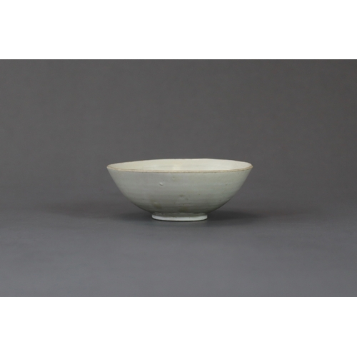 232 - A Ding White-glazed Carved Lotus Bowl, Song dynasty the finely potted body of  rounded flared form r... 