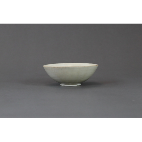 232 - A Ding White-glazed Carved Lotus Bowl, Song dynasty the finely potted body of  rounded flared form r... 