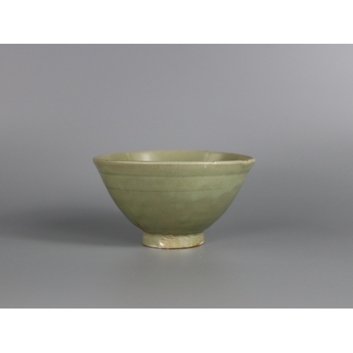 233 - A Yaozhou Celadon Bowl, Song dynasty with deep rounded sides rising from a slightly splayed foot to ... 