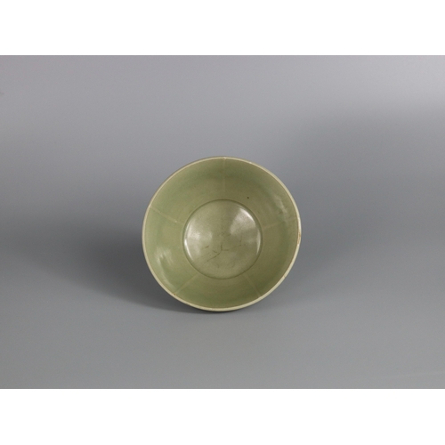 233 - A Yaozhou Celadon Bowl, Song dynasty with deep rounded sides rising from a slightly splayed foot to ... 