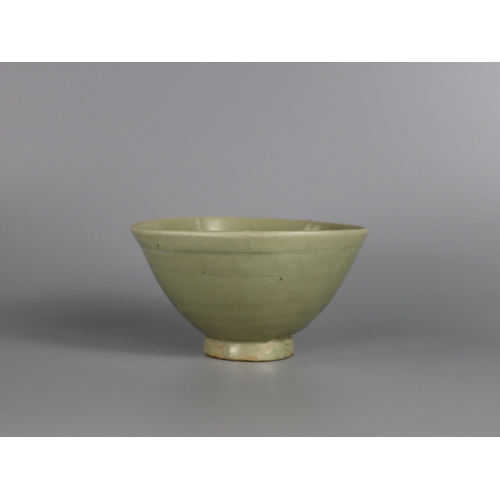 233 - A Yaozhou Celadon Bowl, Song dynasty with deep rounded sides rising from a slightly splayed foot to ... 