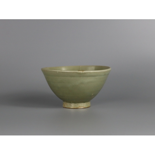 233 - A Yaozhou Celadon Bowl, Song dynasty with deep rounded sides rising from a slightly splayed foot to ... 