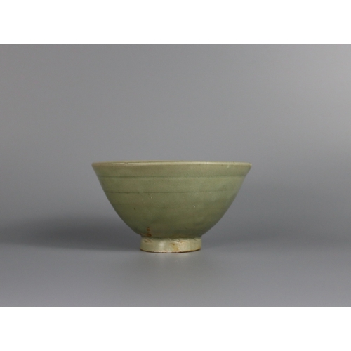 233 - A Yaozhou Celadon Bowl, Song dynasty with deep rounded sides rising from a slightly splayed foot to ... 