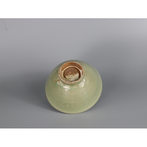 233 - A Yaozhou Celadon Bowl, Song dynasty with deep rounded sides rising from a slightly splayed foot to ... 