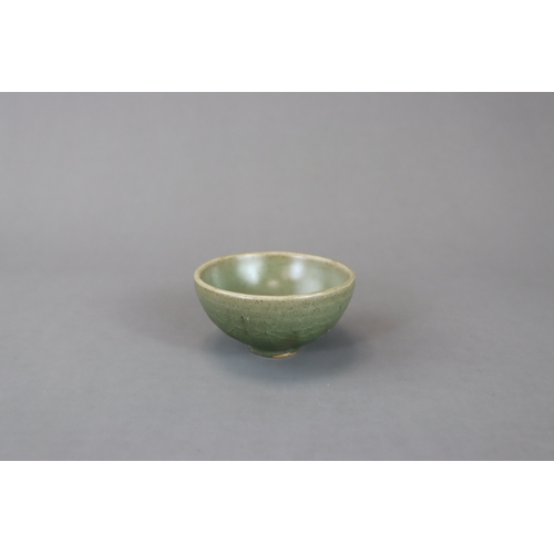 236 - A Small Jun Green-glazed Bubble Bowl, Song dynasty with rounded sides rising from a tapering foot to... 