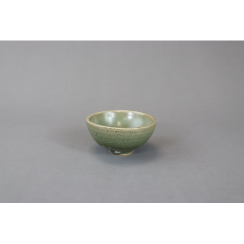 236 - A Small Jun Green-glazed Bubble Bowl, Song dynasty with rounded sides rising from a tapering foot to... 