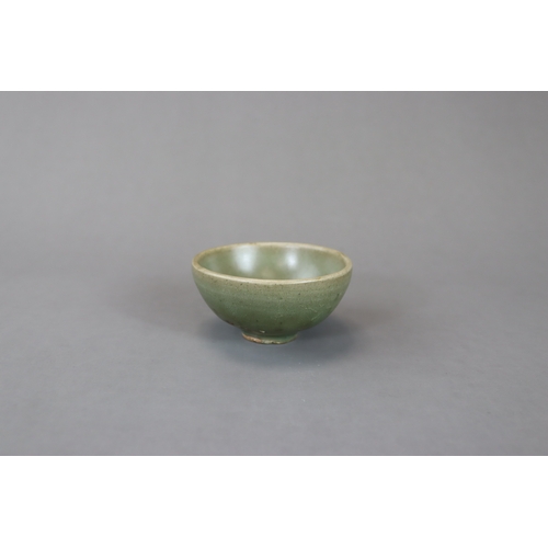 236 - A Small Jun Green-glazed Bubble Bowl, Song dynasty with rounded sides rising from a tapering foot to... 