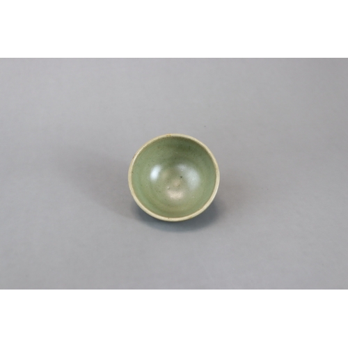 236 - A Small Jun Green-glazed Bubble Bowl, Song dynasty with rounded sides rising from a tapering foot to... 