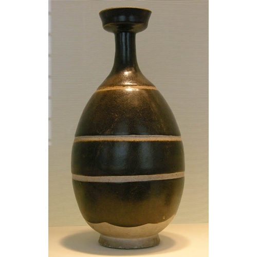 29 - A Rare Black-glazed Baluster Vase, Sui dynasty the well potted vase rising from a solid splayed foot... 