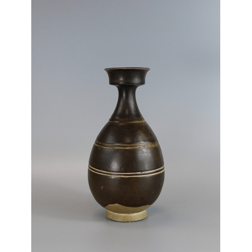 29 - A Rare Black-glazed Baluster Vase, Sui dynasty the well potted vase rising from a solid splayed foot... 