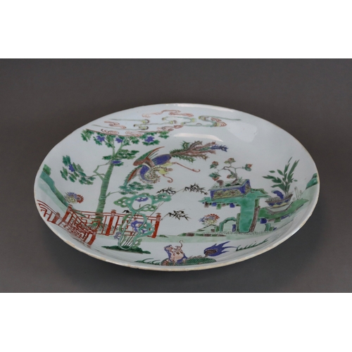 314 - A 'famille verte' Kylin and Phoenix Dish, Kangxi, brightly enamelled with an overall scene of the au... 