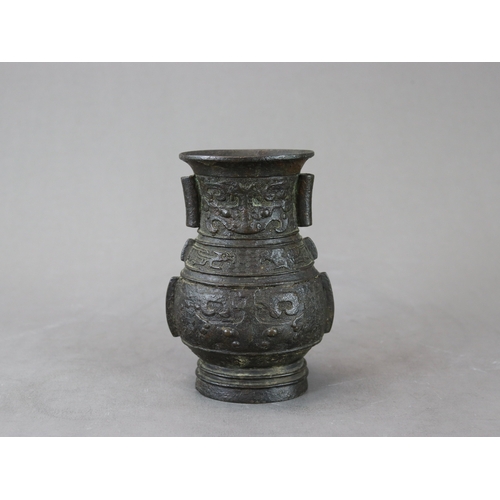 460 - An Archaistic Bronze Vase, hu, Ming dynasty,  the vase of oval section with double arrow handles on ... 