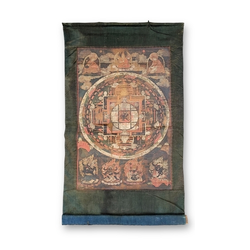 467 - A Mandala Thangka, 18th century,  well painted on cloth on a midnight ground, with the cosmic diagra... 