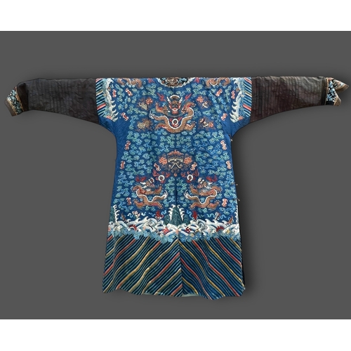 135 - An Embroidered Blue Ground Dragon Robe, 19th century with golden dragons among clouds, interspersed ... 