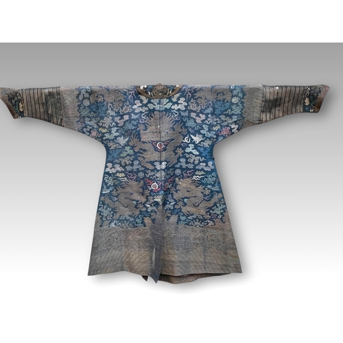 138 - A Blue Silk Gauze Dragon Robe, 19th century finely worked in gold brocade and colours on a deep blue... 