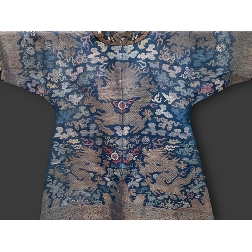 138 - A Blue Silk Gauze Dragon Robe, 19th century finely worked in gold brocade and colours on a deep blue... 