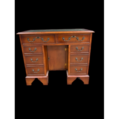 522 - Antique style kneehole desk with tooled leather top and cupboard under 
91.5cm W x 49.5cm D x 75.5cm... 
