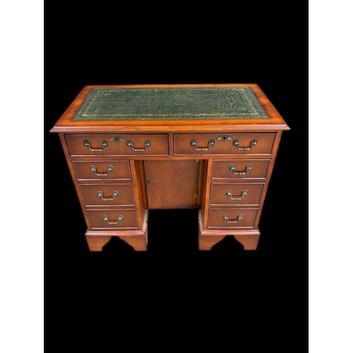 522 - Antique style kneehole desk with tooled leather top and cupboard under 
91.5cm W x 49.5cm D x 75.5cm... 