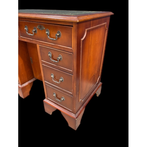 522 - Antique style kneehole desk with tooled leather top and cupboard under 
91.5cm W x 49.5cm D x 75.5cm... 