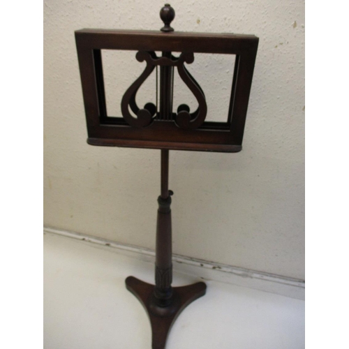 378 - A William IV mahogany music stand with twin supports on adjustable column