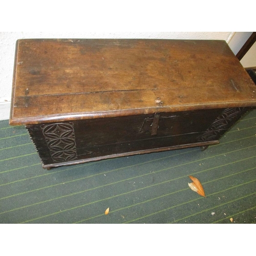 385 - An antique elm coffer having original lock and hinges, carving to front panel.