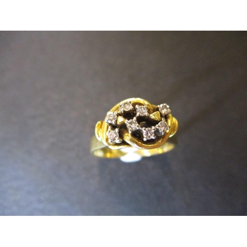 41 - An 18ct yellow gold ring set with 8 diamonds in a stylized setting, approx. ring size P1/2