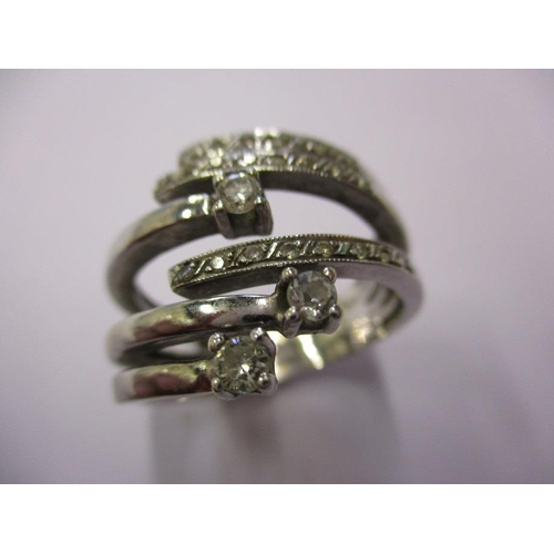 68 - An 18ct white gold and diamond ring in a stylised coil form