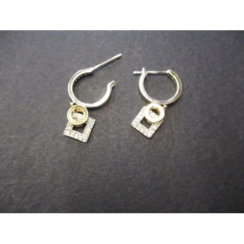 70 - A pair of white gold earrings with yellow gold gem set drops