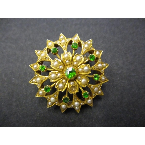 73 - A 15ct yellow gold brooch set with seed pearls and emerald green stones