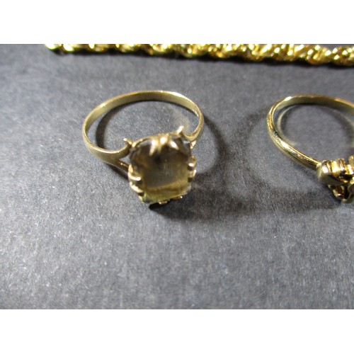 12 - A 9ct gold smokey quartz ring and a yellow metal necklace