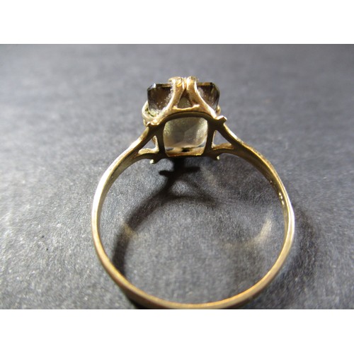 12 - A 9ct gold smokey quartz ring and a yellow metal necklace